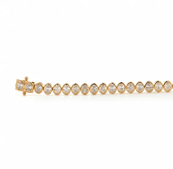 A yellow-gold bracelet lined with round stones in bezel settings.