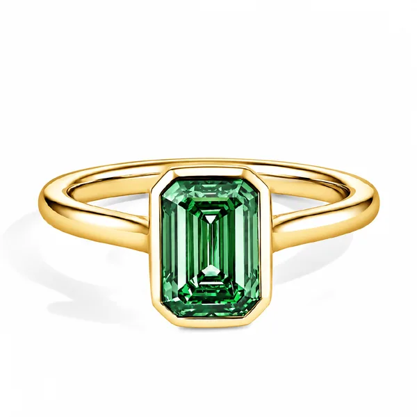 Yellow gold ring with a rectangular green gemstone in a geometric bezel setting.