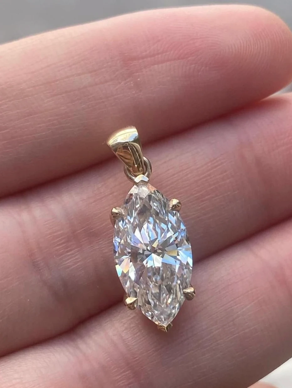 Long white marquise-shaped pendant in a gold-coloured claw setting
