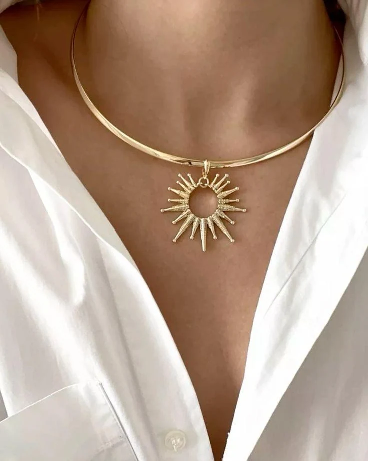 Sunburst pendant worn with a white shirt