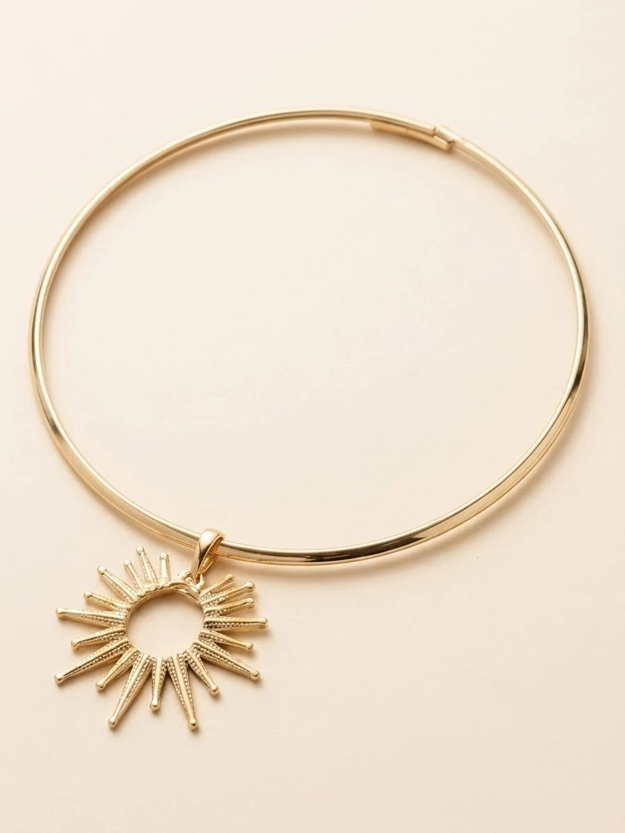 Open sunburst pendant on a close-fitting gold-coloured collar